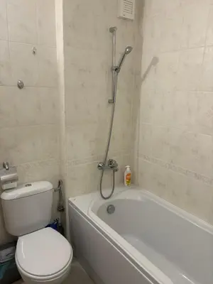 a bathroom with a toilet and a bath tub with a shower at Аспен голф ризорт F204 in Razlog