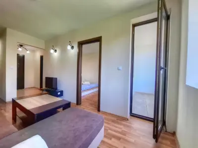 a room with a bed and a table and a mirror at Nevena 206 B&P in Bansko