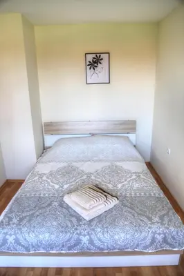 a bed in a room with a picture on the wall at Nevena 206 B&P in Bansko