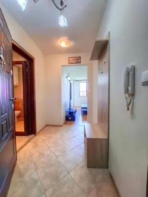a hallway with a room with a television and a door at Nevena 206 B&P in Bansko