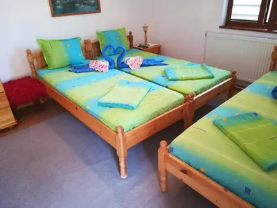 two beds in a room with green and blue at Villa Bulgarka in Divchovoto