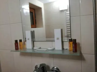 a bathroom with a mirror and a glass shelf at Villa Bulgarka in Divchovoto