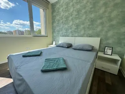 a bedroom with a bed with two towels on it at 63rd Luxury One Bedroom Apartment in Sofia