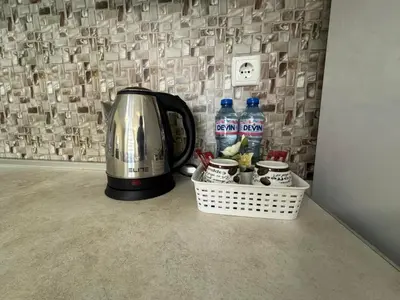 a coffee maker and water bottles on a counter at 63rd Luxury One Bedroom Apartment in Sofia