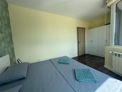 a bedroom with a bed with two towels on it at 63rd Luxury One Bedroom Apartment in Sofia