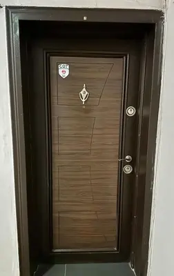 a wooden door with two stickers on it at Apartment top center Maria in Sofia
