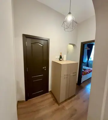 a room with a black door and a white cabinet at Apartment top center Maria in Sofia