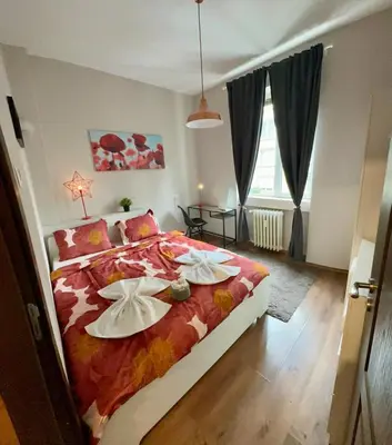a bedroom with a bed with flowers on it at Apartment top center Maria in Sofia