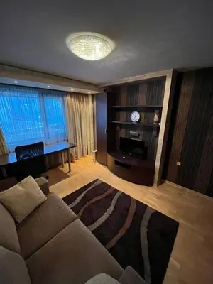 a living room with a couch and a table at Apart Burel 56 in Sofia