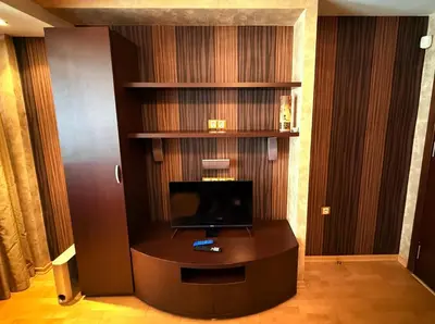a living room with a tv and a desk with a television at Apart Burel 56 in Sofia