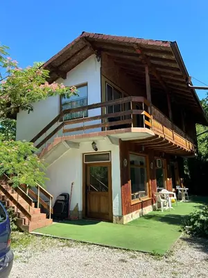 a small house with a balcony and a porch at Guest House Efrosina in Glozhene