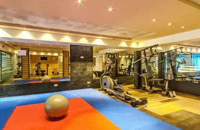 a fitness room with a gym with tread machines at Bansko LUXURY 2 bedroom apartment - SKI&SPA resort in Bansko