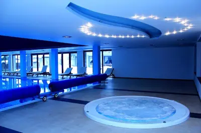 a large room with a large pool with blue lighting at Bansko LUXURY 2 bedroom apartment - SKI&SPA resort in Bansko