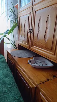 a wooden cabinet with a plate on a counter at Родопско сърце in Chepelare
