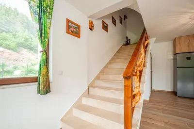 a staircase in a house with a window at Къща за гости Крис in Smolyan