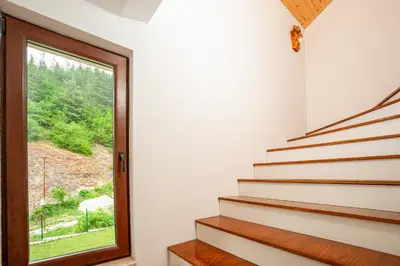 a staircase with a window in a house at Къща за гости Крис in Smolyan