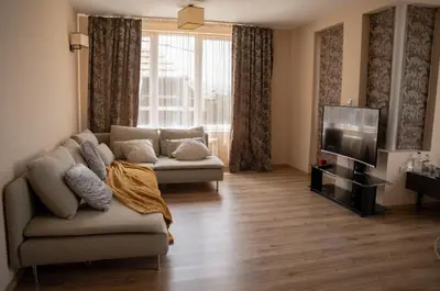 a living room with a couch and a tv at Paradise Nest in Sofia