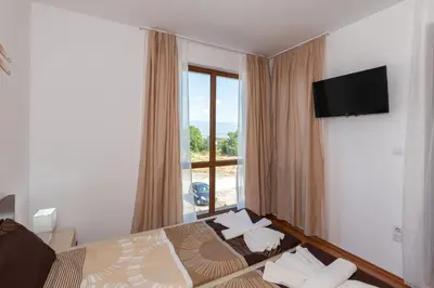 a hotel room with a bed and a window at Belvedere 2bedroom private apartment in Bansko