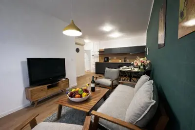 a living room with a couch and a table with a bowl of fruit at Delux 3 - Plovdiv Модерен апартамент,2 спални,център in Plovdiv