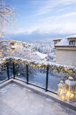 a balcony with a view of snow covered mountains at Delux 3 - Plovdiv Модерен апартамент,2 спални,център in Plovdiv