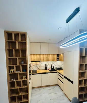 a kitchen with white cabinets and wooden shelves at Atana Home Drujba in Sofia