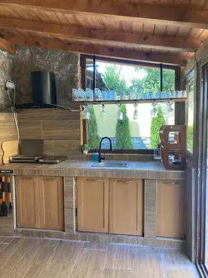 a kitchen with a sink and a window at Guest house Dinaya-2 in Dobrinishte