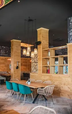 a dining room with a wooden table and chairs at MG Homes - City Park Inn in Plovdiv