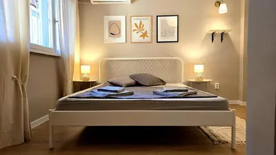 a bed in a bedroom with two lamps and two tables at Hidden Courtyard Gem - House in Sofia Center in Sofia