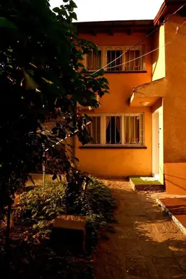 a building with a tree in front of it at Hidden Courtyard Gem - House in Sofia Center in Sofia