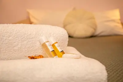 a couple of bottles of essential oils sitting on a towel at Casita Central - FREE Private Parking & Metro station in Sofia