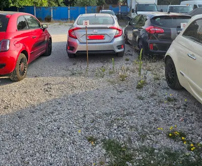 a row of parked cars in a parking lot at Casita Central - FREE Private Parking & Metro station in Sofia