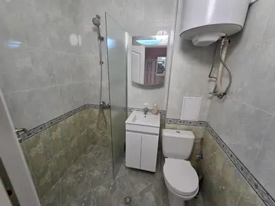 a bathroom with a shower and a toilet and a sink at Paradise Studio NBU in Sofia