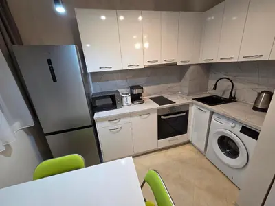 a kitchen with a refrigerator and a washing machine at Paradise Studio NBU in Sofia