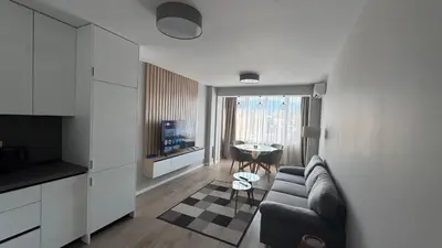 a living room with a couch and a table at Modern and cozy apartment in the city centre in Sofia