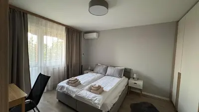 a bedroom with a bed with towels on it at Modern and cozy apartment in the city centre in Sofia