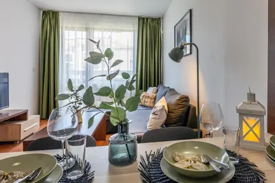 a living room with a table with a vase on it at Alpine Escape Bansko in Bansko