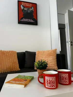 a table with two coffee mugs and a book on it at Rea Silena - Modern and Stylish Studio in Sofia