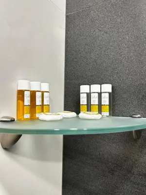 a shelf with four bottles of honey on it at Rea Silena - Modern and Stylish Studio in Sofia