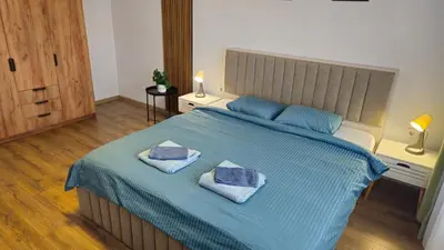 a bedroom with a blue bed with two pillows on it at Stylish 2-Bedroom Apartment in Top Center - 5m walk to Metro station Serdika, Sofia statue -- 1 FullBath & 1Washroom in Sofia