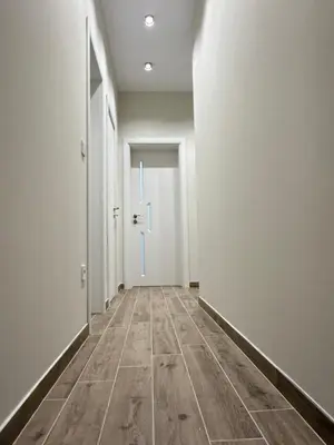 an empty hallway with white walls and wooden floors at Stylish 2-Bedroom Apartment in Top Center - 5m walk to Metro station Serdika, Sofia statue -- 1 FullBath & 1Washroom in Sofia