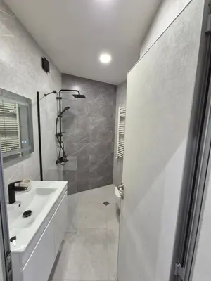 a white bathroom with a shower and a sink at Stylish 2-Bedroom Apartment in Top Center - 5m walk to Metro station Serdika, Sofia statue -- 1 FullBath & 1Washroom in Sofia
