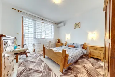 a bedroom with a bed and a dresser at Villa Cometa Pamporovo - 1BD Near Slope #7 by Flat Manаger in Pamporovo