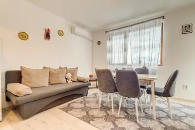 a living room with a couch and a table at Villa Cometa Pamporovo - 1BD Near Slope #7 by Flat Manаger in Pamporovo