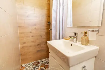 a bathroom with a sink and a mirror at Дедовата Къща in Dedovo