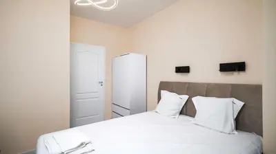 a bedroom with a bed with white sheets and pillows at Cosy & Modern 1BD Flat close to NDK by Flat Mаnager in Sofia