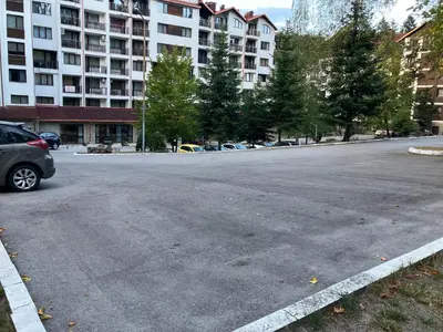 an empty parking lot in front of a large building at Borovets Gardens apartment C-43 in Borovets