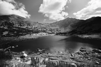 a black and white photo of a lake in the mountains at Borovets Gardens apartment C-43 in Borovets