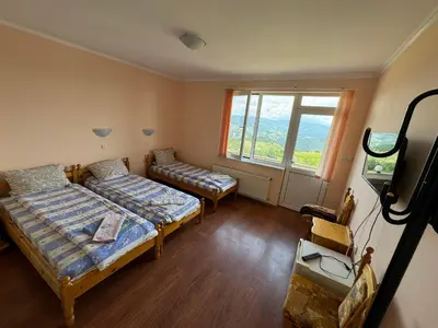 a room with two beds and a window at Guest House Chala in Chala