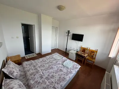 a bedroom with a bed and a television in it at Guest House Chala in Chala
