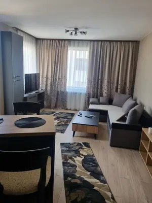 a living room with a couch and a table at Apartament Rumqncev in Velingrad
